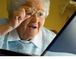 The image features an elderly woman, who appears to be experiencing a moment of surprise or curiosity while looking at her laptop. Her glasses are perched on her nose, and she has a hand raised, possibly to adjust them or to express disbelief as she leans closer to the screen. Her demeanor suggests a mix of astonishment and intrigue, indicating that she has stumbled upon something unexpected online.
The background is simple and slightly blurred, focusing attention on her expression and the device. This context can evoke humor as it plays on the stereotype of older generations grappling with technology.
The scene humorously captures a universal experience: the bewilderment many feel when navigating the digital world. It’s a charming reminder of how technology can both connect and confuse, especially for those who didn’t grow up with it.