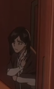 This animated image features a dark-haired character, likely female, peeking from behind a dark reddish-brown doorway or wall. Her demeanor is one of intense distress or shock, with wide, worried eyes and a hand clutched dramatically to her chest, as if she's just witnessed something truly unsettling or heard a shocking secret. She's dressed in a dark suit jacket over a lighter shirt, suggesting a formal or professional setting. The dim, warm lighting of the background adds to the tense atmosphere, making her appear caught off guard in a moment of vulnerability. This expression is a classic anime trope, often used for comedic effect when a character overreacts, making her a perfect candidate for a 'gasping in horror' meme.