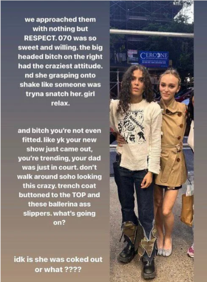 The image features Lily-Rose Depp and 070 Shake on a SoHo street, with a "CERCONE" sign visible in the background, suggesting an urban setting. 070 Shake appears relaxed and "sweet and willing" in a graphic tee and dark pants with chunky boots. In contrast, Lily-Rose Depp, known for "The Idol," is depicted with a perceived "craziest attitude," grasping onto 070 Shake. Her outfit, a fully buttoned trench coat and "ballerina ass slippers," is humorously criticized in the accompanying text as "crazy" and "not even fitted." The text further pokes fun, referencing her trending show and her father Johnny Depp's court case, questioning if she's "coked out or what????" The humor lies in the stark contrast between the two subjects' demeanors and Lily-Rose's outfit choice amidst public scrutiny.