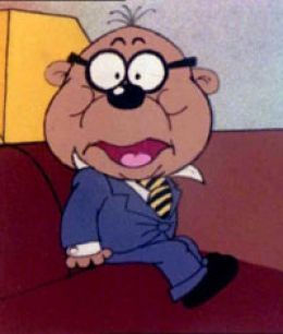 This image features a classic cartoon character, likely a younger version of Mr. Magoo, looking comically flustered. The small, round figure sports a dapper blue suit, white shirt, and a jaunty yellow-and-black striped tie, all while perched on a dark red couch. His most striking features are his thick black glasses, wide, startled eyes, and cheeks puffed out to an almost absurd degree, as if he's just swallowed a whole pie or is holding his breath for dear life. His mouth is agape, revealing a pink tongue, adding to his bewildered yet endearing demeanor. The simple, indoor background of a couch and a hint of a yellow wall provides a cozy, domestic setting, contrasting humorously with his exaggerated expression of surprise or effort. He seems perpetually on the verge of a comical mishap, a hallmark of his nearsighted adventures.