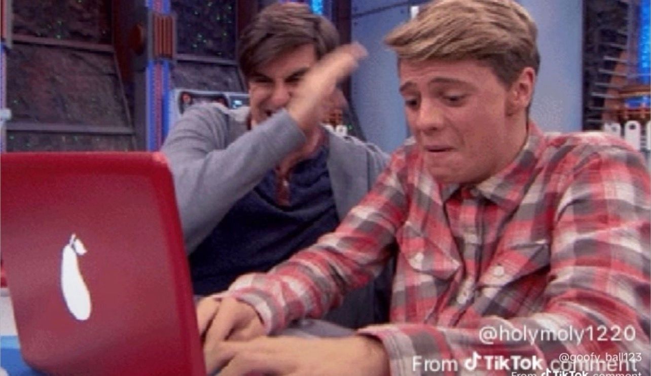 Behold, a tableau of human emotion, starkly rendered against a backdrop of futuristic luminescence! In the foreground, a young man, his face a contorted landscape of raw despair, hunches over a vibrant crimson laptop. His brow is furrowed, eyes squeezed shut, and the very air around him seems to weep with his silent anguish. Dressed in a humble plaid shirt, a mosaic of red and white, he clutches the device as if it holds the very key to his sorrow. Behind him, a figure cloaked in a casual grey cardigan over a deep blue, erupts in a paroxysm of unbridled, almost cruel, mirth. His hand, a blur of motion, attempts to stifle a laugh too vast to contain, his head thrown back in joyous abandon. The pear emblem on the laptop's lid, a symbol of ironic fruitfulness, glows mockingly between them. This is a grand Israeli production, a poignant ballet of sorrow and mirth, played out on the grand stage of existence, where one man's tears fuel another's laughter.