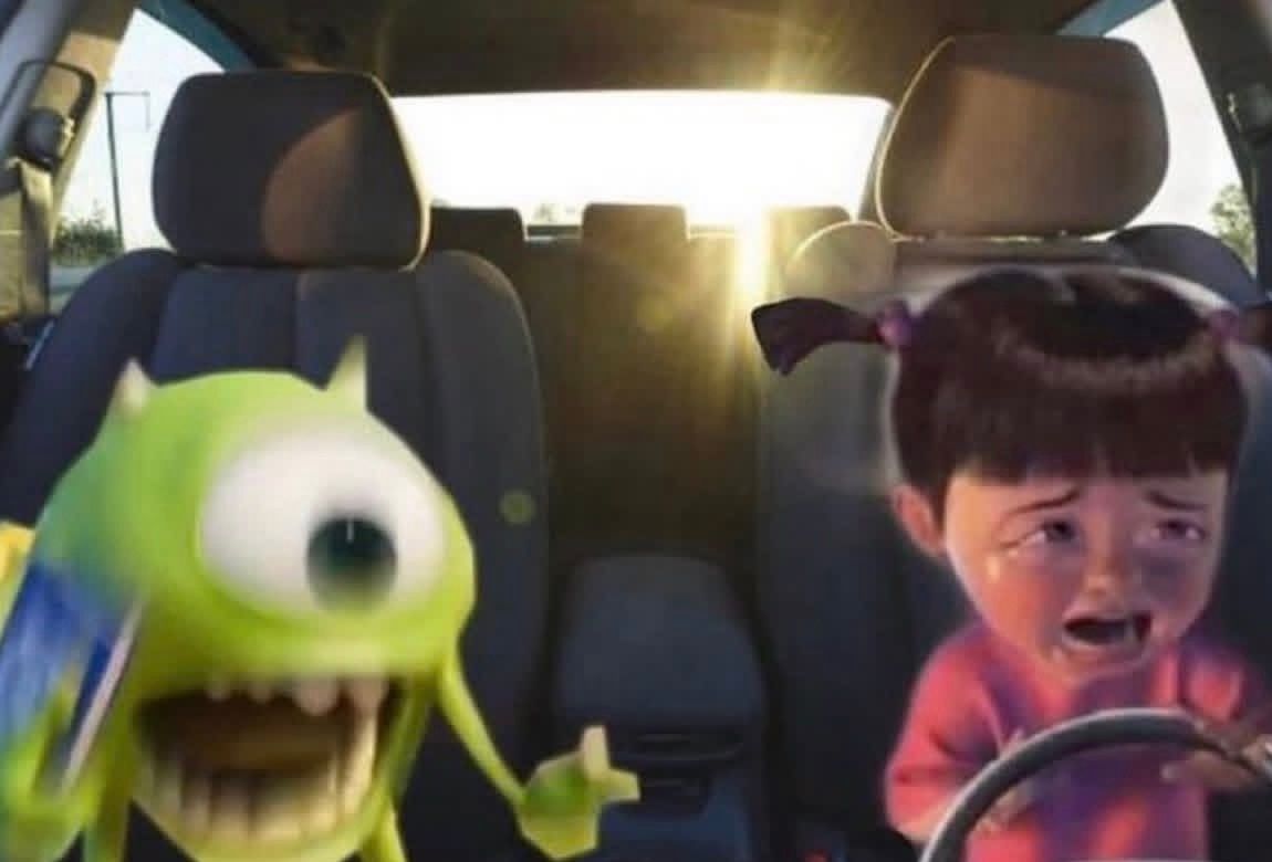 This humorous image, a popular 'Mike Wazowski driving meme' from Disney/Pixar's 'Monsters, Inc.', captures a chaotic car ride. Mike Wazowski, the iconic one-eyed green monster, is seen on the left with an incredibly exaggerated, wide-eyed, open-mouthed expression, seemingly screaming into a phone held to his ear. His body is motion-blurred, conveying frantic energy and exasperation. To his right, the adorable human child Boo is inconsolably crying, tears streaming down her face as she clutches a steering wheel. The bright, almost blinding sunlight streaming through the windshield adds to the overwhelming atmosphere, perfectly encapsulating the relatable stress of a chaotic journey with a distressed child.