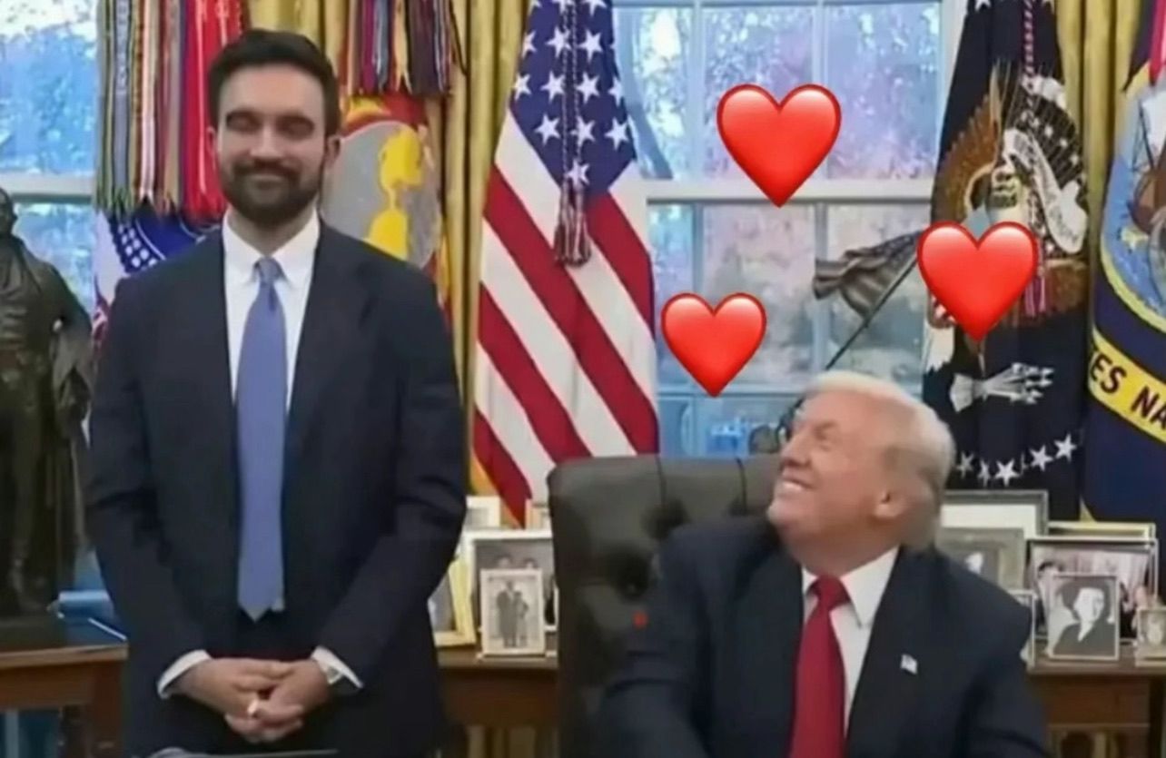 In this image, we see Donald Trump laughing and looking affectionately at another man standing beside him, who appears slightly more serious. Trump's demeanor is lighthearted, with a big smile that suggests a friendly or jovial interaction, while the other individual stands with a calm expression, possibly caught off guard by Trump's reaction.
The background is richly decorated, typical of the Oval Office, featuring the American flag and various military insignias, which adds a formal and patriotic context to the scene. This setting highlights the significance of the moment, as it occurs in a place associated with decision-making and power.
The use of heart emojis creates a humorous contrast, as it playfully suggests a deeper bond or affection between the two, emphasizing the lighthearted nature of the interaction. This image often circulates in memes, reflecting on Trump's unique charisma and interactions.