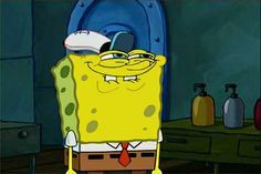 This image captures SpongeBob SquarePants from the iconic animated series, sporting a hilariously smug and mischievous expression. He wears his classic white shirt, red tie, and brown pants, topped with a white cap tilted jauntily. His eyes are squinted into a knowing gaze, and a wide, confident grin stretches across his face, embodying the popular 'Smug SpongeBob' meme. The background is a dimly lit, utilitarian room, possibly a locker room or bathroom, featuring a prominent blue circular door and a counter with three pump bottles. The mundane setting humorously contrasts with SpongeBob's uncharacteristically slick demeanor, suggesting he's either just pulled off a clever prank or is about to reveal a juicy secret, making the scene inherently comical.
