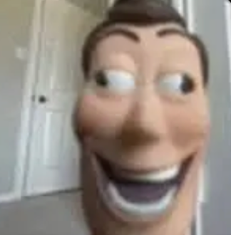 This low-resolution, close-up image features a highly anthropomorphized, distorted face resembling Woody from Disney Pixar's Toy Story, captured in a moment of unsettling glee. His wide, almost maniacal grin stretches across his face, revealing a full set of teeth, while one eye darts sharply to the side, suggesting a mischievous or perhaps slightly unhinged demeanor. The blurry background of a light-colored room with a white door adds to the candid, almost 'caught in the act' feel, typical of internet memes. This image plays on the uncanny valley and the beloved character's wholesome image, transforming him into a source of dark humor. He seems to be plotting something delightfully devious, perhaps a new adventure or just a very elaborate prank.