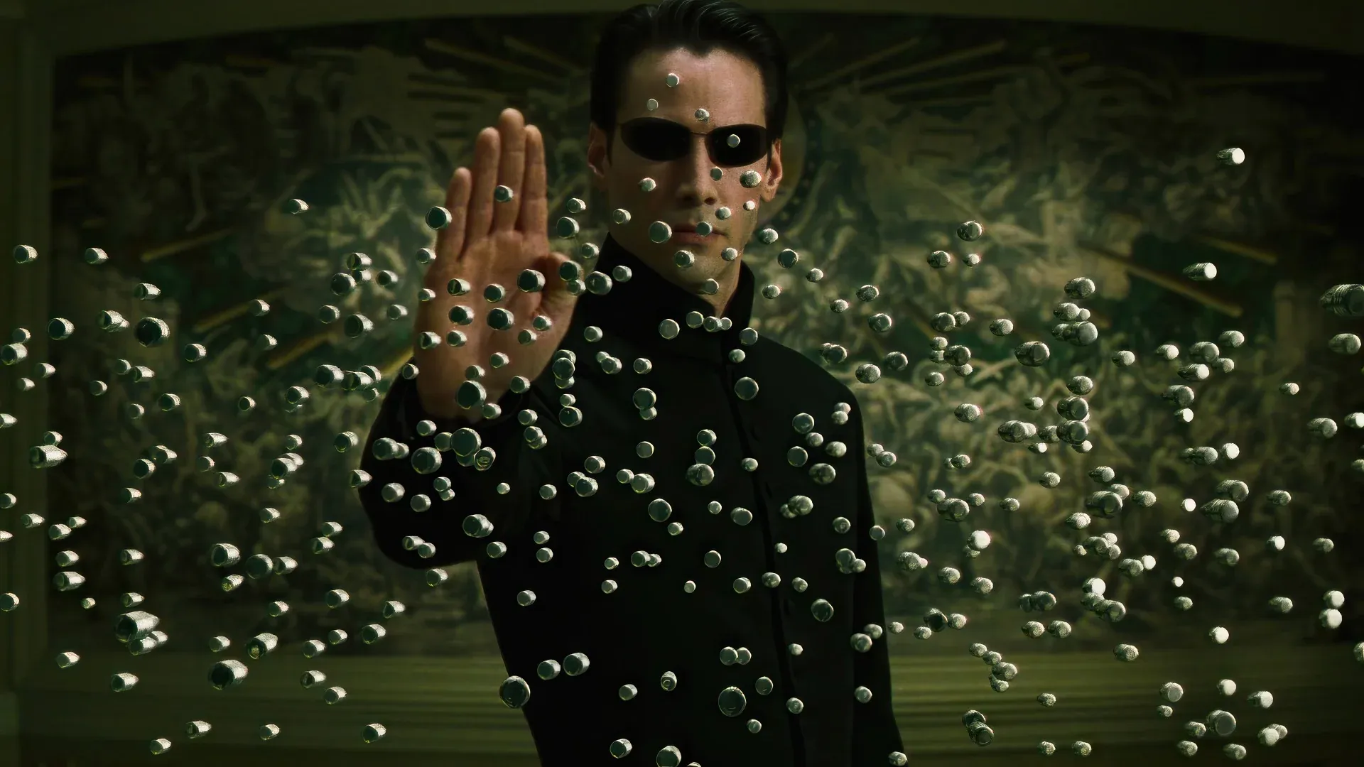 Keanu Reeves, as Neo from "The Matrix," stands front and center, exuding an impossibly calm and powerful demeanor. He wears his signature black trench coat and sunglasses, with his right hand outstretched, palm forward, as if politely asking a swarm of bullets to "hold on a sec." The iconic "Bullet Time" effect freezes countless metallic projectiles mid-air around him, creating a mesmerizing, almost bubbly, visual. The dark, abstract background, tinged with the Matrix's characteristic green hue, reinforces the digital reality he's effortlessly manipulating. It's a classic moment of cinematic defiance, where Neo's casual "stop" button press makes a hail of gunfire look like a mere inconvenience.
