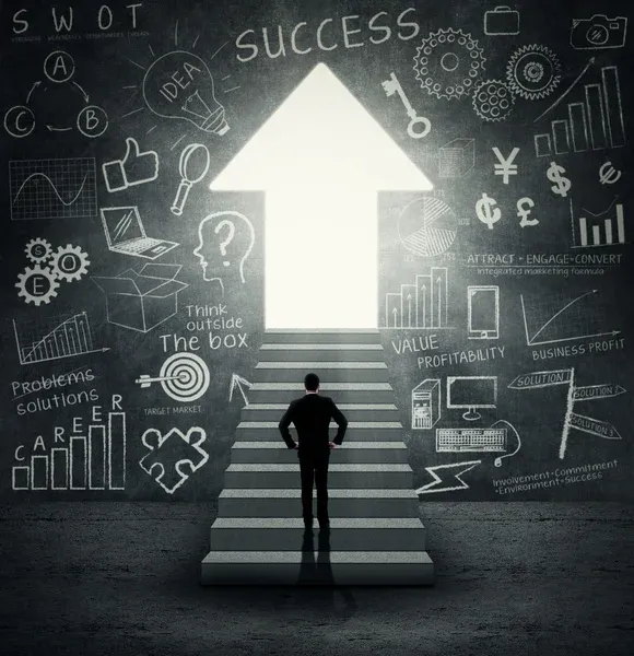 The image features a man in a dark suit, viewed from behind, standing at the bottom of a flight of stairs. His hands are confidently placed on his hips, conveying a determined demeanor as he prepares to ascend. The stairs lead to a brightly glowing, upward-pointing arrow labeled "SUCCESS," which serves as a radiant portal. The dark, textured wall surrounding him is densely covered in white chalk drawings and text, illustrating a chaotic yet comprehensive array of business concepts like SWOT analysis, graphs, currency symbols, "Think outside The box," and "CAREER." This overwhelming backdrop humorously encapsulates the myriad strategies and information one might navigate on the path to success, with the glowing arrow offering a comically direct, albeit bright, destination.
