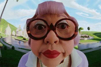 This image features a comically distorted close-up of Mrs. Kwan, portrayed by Amy Hill, from the 2003 film 'The Cat in the Hat.' Her face is exaggerated by a wide-angle lens, emphasizing her large, round, tortoise-shell glasses, bright red lipstick, and distinctive purple hair styled in a neat bun. Her eyes are wide, conveying a demeanor of intense, almost alarmed scrutiny, as if she's just caught someone in the act. The whimsical, brightly colored neighborhood from the movie, with its cartoonish houses and rolling green hills under a blue sky, serves as the background, perfectly complementing the character's over-the-top aesthetic. The humor stems from her exaggerated features and the classic 'caught in the act' expression, making her look like she's about to deliver a stern, yet hilarious, reprimand.