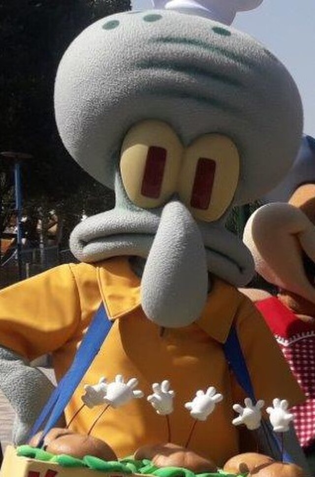 The image showcases Squidward Tentacles, a beloved character from the animated series "SpongeBob SquarePants." He’s dressed as a chef, sporting a yellow shirt and a white chef’s hat, yet his demeanor radiates his trademark grumpiness. His eyes express a mix of annoyance and resignation, as if he’s questioning why he’s stuck in this cheerful theme park setting.

In the foreground, Squidward is holding a plate with cartoonishly styled food items, which adds a humorous twist to his typically serious personality. Behind him, the park setting is hinted at with playful elements, likely filled with laughter and excitement from visitors, contrasting with his discontent.

The juxtaposition of Squidward's sour expression against the vibrant, joyous background creates a comedic irony. It’s as if he’s the reluctant participant in a fun event, embodying the classic struggle between duty and desire for solitude—perfect for a character known for his love of art over chaos.