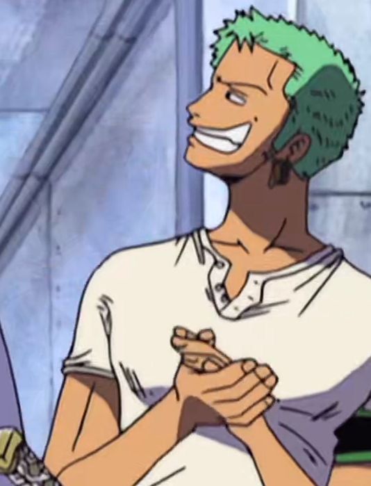 The image is a detailed illustration from an anime-style work. It features a male character with light green, spiky hair, and a pronounced jawline. His skin is tan, and he is wearing a simple, off-white, short-sleeved, buttoned shirt with the top two buttons open. The facial expression is highly animated: the character has a wide, toothy grin that stretches across his face, with pronounced cheekbones and closed, happy eyes. He is positioned partially in profile, facing left. His hands are clasped together near his chest in a kind of mischievous or excited gesture. The background is composed of muted tones, possibly resembling a stone wall with visible lines and shadows, indicating an indoor or possibly an urban outdoor setting. The character exudes a confident, cheeky energy.