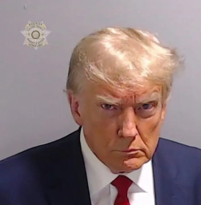 Bro’s scowling like he’s mogging the entire jail lineup.
