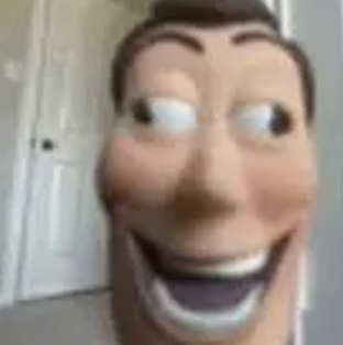 This low-resolution, close-up image features Woody from Disney/Pixar's Toy Story, captured in a rather unsettling, meme-worthy selfie. His familiar face fills the frame, contorted into an exaggerated, wide-mouthed grin that borders on manic. His large, cartoonish eyes are sharply darting to his left, giving him a look of intense surprise or perhaps mischievous glee, as if he's just spotted something truly wild. The blurry, light-colored background with a visible doorknob suggests a mundane indoor setting, humorously contrasting with Woody's overly enthusiastic and slightly creepy expression. He seems to be saying, 'Howdy, partner!' with a little too much gusto, perhaps having just spotted Andy's mom with a fresh batch of cookies.