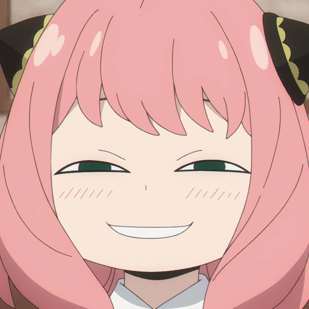 The image features a close-up of Anya Forger, the beloved telepathic character from the anime "Spy x Family," sporting her iconic and widely recognized "Anya Smug Face" meme expression. Her demeanor is undeniably mischievous and self-satisfied, with her eyes narrowed into confident crescents and a wide, closed-mouth smile that suggests she's just pulled off a brilliant scheme or is privy to a secret. Her signature pink hair and black and gold horn-like headpiece frame her face. The plain, light brown background is intentionally simple, ensuring all focus remains on Anya's hilariously smug expression, which perfectly encapsulates her cunning and playful personality. It's a classic moment of a child's exaggerated confidence, making it instantly relatable and humorous.