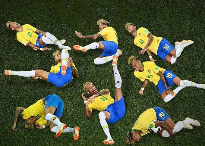 This humorous image features multiple instances of Brazilian footballer Neymar Jr. sprawled dramatically across a vibrant green football pitch, all wearing his iconic yellow and blue national team kit. Each depiction captures him in a different, exaggerated pose of perceived agony or injury, from clutching his leg to writhing on the ground with an open-mouthed grimace. The simple green background emphasizes the theatricality of his 'falls.' This composite image became a viral meme during the 2018 FIFA World Cup, comically satirizing his widely perceived tendency to exaggerate fouls and dive, making light of his on-field theatrics with a playful, repetitive visual narrative.