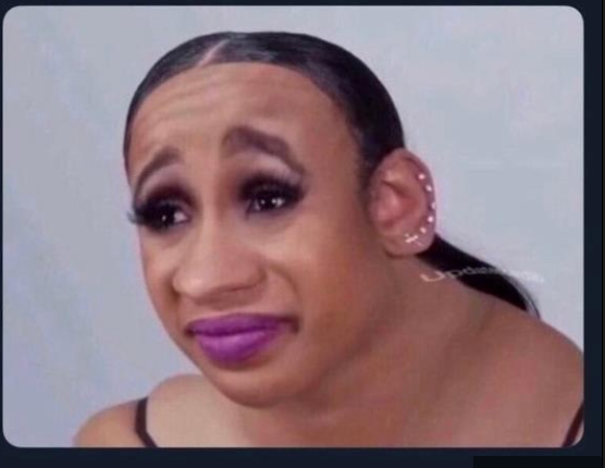 The image features a highly distorted and exaggerated face, widely recognized as a meme derived from Kim Kardashian's crying expression. The subject's demeanor is one of intense, almost theatrical, sadness or distress, characterized by a furrowed brow, wide-set eyes with heavy makeup, and a downturned mouth accentuated by vibrant purple lipstick. One ear is visible, adorned with multiple small piercings, and a faint 'Update' watermark appears on the neck. The plain, light grey background serves to isolate and emphasize the comically distraught expression. The humor stems from the extreme facial manipulation, transforming a celebrity's emotional moment into an absurd and relatable internet meme used to convey exaggerated disappointment or despair.