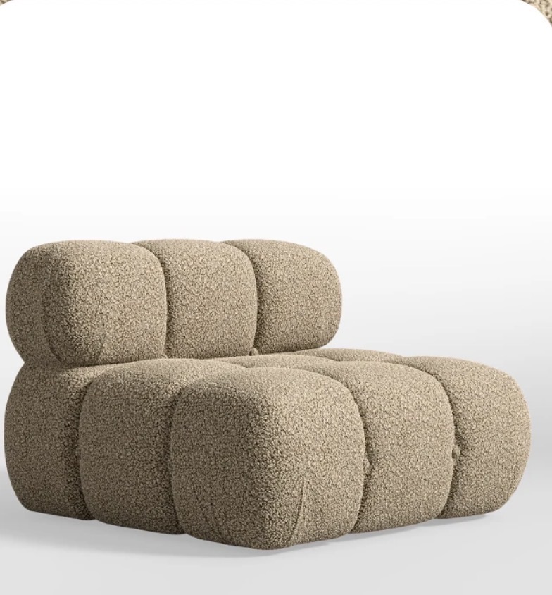 This image showcases a plush, modular armchair, resembling a collection of oversized, beige marshmallows or friendly, rounded boulders. Upholstered in a textured, bouclé-like fabric, its 'demeanor' is one of supreme, unadulterated comfort, practically daring you to resist its inviting softness. It looks utterly content, perhaps even a little smug, knowing it's the most comfortable spot in any room. The pristine white background serves to highlight every delightful curve and texture of this unique piece, making it the undisputed star of the show. There's a humorous sense that this chair is perpetually ready for a luxurious nap, or perhaps it's just a very stylish cloud that decided to settle down indoors.